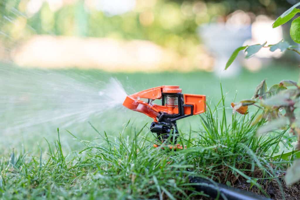 Close up of a sprinkler system in a green landscaped area (for Parterre Garden Services case study by OptConnect, July 2024)