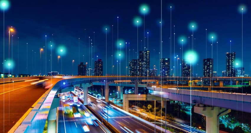 Modern cityscape and communication network concept, for article on IoT and wireless signal strength, OptConnect 2024.