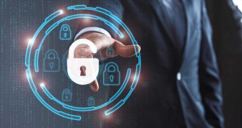Audit your IoT connectivity provider (person in background pointing to a glowing icon with a lock on it)